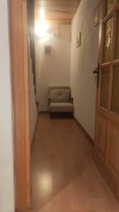 a hallway with a door and a couch in a room at La casa del Amo , Trasmoz Y Moncayo in Trasmoz