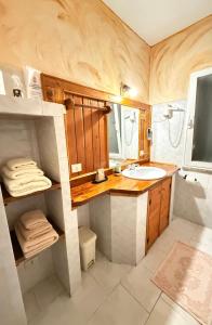 a bathroom with a sink and a mirror at B&B Sa Bèrtula in La Maddalena +45 photos