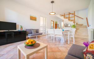 a living room with a couch and a table with a bowl of fruit at Lovely Home In Piane Vecchie,Lascari in Lascari
