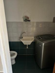 a small bathroom with a sink and a toilet at Casa bonita de zona norte in Rosario