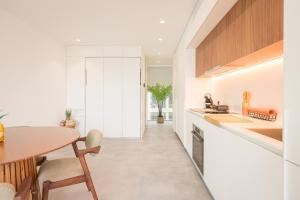 a kitchen with a table and a dining room at Aveiro Central Appartment in Aveiro