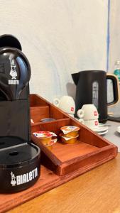 a coffee maker sitting on top of a wooden tray at B&B Sa Bèrtula in La Maddalena