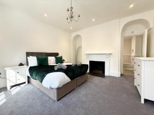 a bedroom with a large bed and a fireplace at Pennsylvania House in Exeter