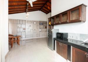 a kitchen with a refrigerator and a table in it at Araliya Villas in Ja-Ela