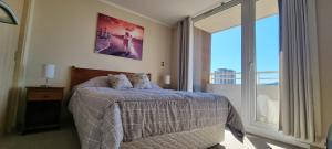 En eller flere senge i et værelse på Departamento completo, centrico y estacionamiento