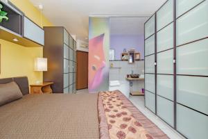 a bedroom with a large bed and a bathroom at Carthusia View - Affitti Brevi Italia in Certosa di Pavia