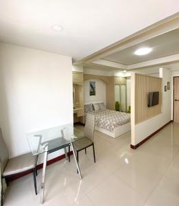 a hotel room with a desk and a bed at Impress Town Condo at Nimman 704 in Chiang Mai +6 photos