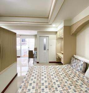 a bedroom with a bed and a dining room at Impress Town Condo at Nimman 704 in Chiang Mai