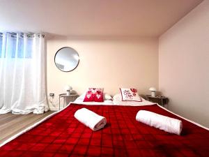 a bedroom with two beds with a red blanket at Green garden apartment in Lignano Sabbiadoro