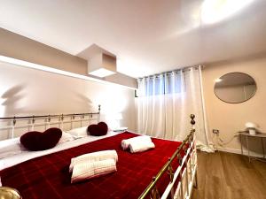 a bedroom with a large bed with red blanket at Green garden apartment in Lignano Sabbiadoro