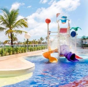 a water park with a water slide in a pool at Salinas Park Resort in Salinópolis