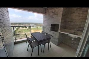 a table and chairs on a balcony with a view at Salinas Park Resort in Salinópolis