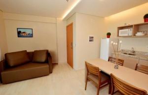 a living room with a couch and a table at Salinas Park Resort in Salinópolis +1 photo