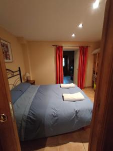 a bedroom with a bed with two towels on it at Studio idéal court séjour in Porté-Puymorens