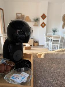 a black coffee maker sitting on a table at BARROSA CON ENCANTO, AC - WIFI - PARKING, Parejas y familias in Novo Sancti Petri +18 photos