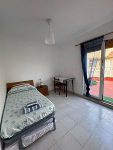 a bedroom with a bed and a table and a window at Mabel in San Javier