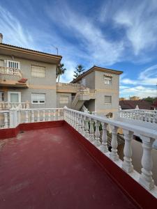 a balcony with a white railing next to a building at Mabel in San Javier
