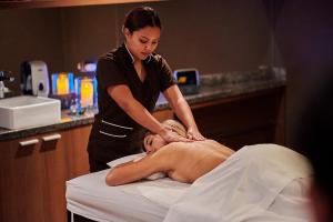 a woman is getting a massage from a massage therapist at Casa Andina Premium Golf Los Incas in Lima