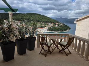 a table and chairs on a balcony with a view at Dream - sea view apartment in Pučišća