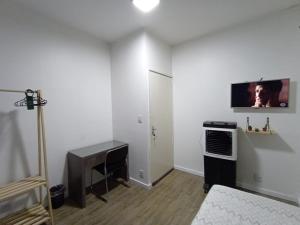 a living room with a television on the wall at Casa do Naldo in Brasília