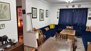 a living room with a blue couch and a table at شقة الفن Art Apartment in Marrakesh