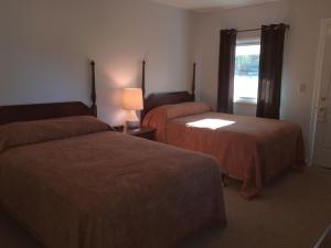 A bed or beds in a room at McGregor Inn Motel