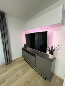 a living room with a flat screen tv on a wall at Terrace 24 Urban Stay in Villingen-Schwenningen