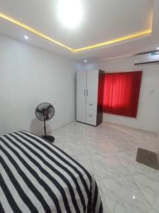 a bedroom with a black and white bed and red cabinets at Crystal homes in Lagos