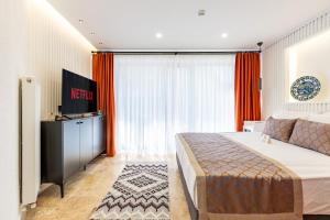 a hotel room with a bed and a television at BAB - by Menar Hotel in Istanbul