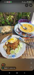a table with two plates of food on it at Eltari Homestay in Tetebatu +33 photos