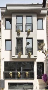 an apartment building with flowerpots on the balconies at BAB - by Menar Hotel in Istanbul
