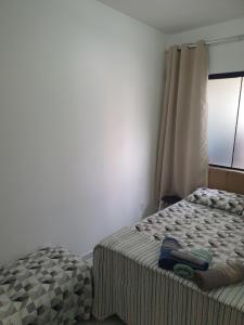 Ένα ή περισσότερα κρεβάτια σε δωμάτιο στο Quarto & Conforto