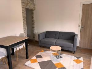 a living room with a couch and a table at Appartement T3 - Plage à 500m in Saint-Nazaire
