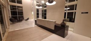 a lobby with a reception desk in a building at Ilha Pura Barra in Rio de Janeiro