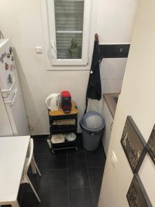 a small kitchen with a table and a refrigerator at Appartement Montrouge in Montrouge