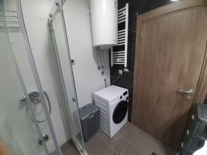 a small bathroom with a toilet and a shower at Apartman Beograd Mir i Komfor in Belgrade +39 photos
