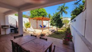 an outdoor patio with a wooden table and a tent at Hotel Monserrat in Mérida