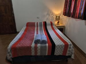 Una cama o camas en una habitación de Hostel VERBENITA