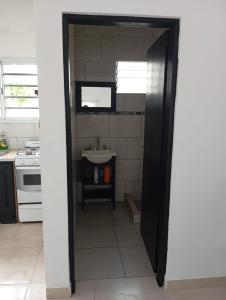 una cucina con porta che conduce a un lavandino di El Quincho de Ampi a Chascomús