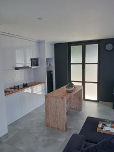 a kitchen with a wooden table in a room at Villa cecile in Balian