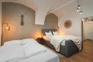 a bedroom with two beds and a guitar on the wall at NOOR - Golden Mood or Cinema Luxe in Graz