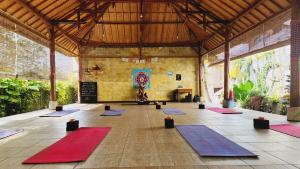 a large room with a bunch of yoga mats at Villa cecile in Balian