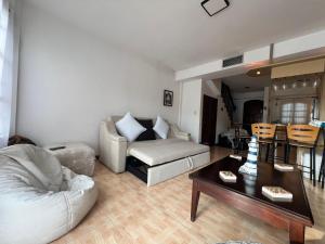 a living room with a couch and a table at Villa con Muelle Privado en Pueblo Viejo VIP INTER FIBRA in El Morro de Barcelona