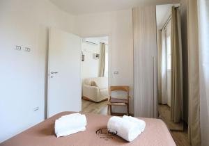 a bedroom with a bed with two towels on it at La Casetta in Tuglie