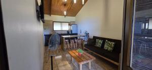a living room with a couch and a table at Apartamentos Tupuna Lodge in Hanga Roa