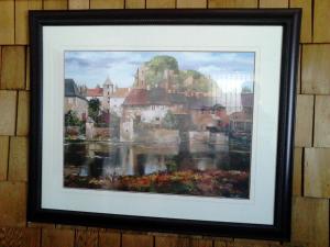 a framed painting of a city on a wall at Vacation Cottage in Canora