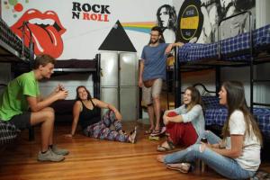 a group of people sitting in a room with bunk beds at Play Hostel Soho in Buenos Aires