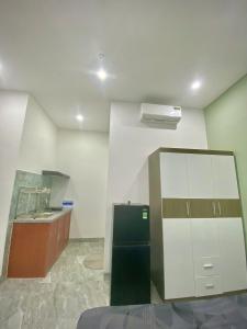 a kitchen with a sink and a refrigerator at HG House in Da Nang +1 photo