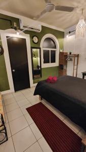 a bedroom with a bed and a clock on the wall at Frida Downtown Apart in Playa del Carmen