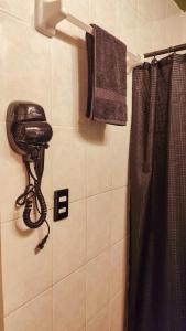 a bathroom with a phone on the wall next to a shower at Frida Downtown Apart in Playa del Carmen